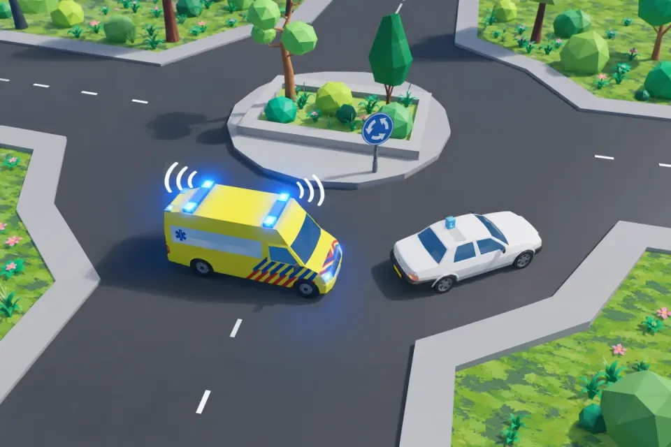 The ambulance approaches the learner car on the roundabout. Calmly keep going round and do not suddenly take an exit.