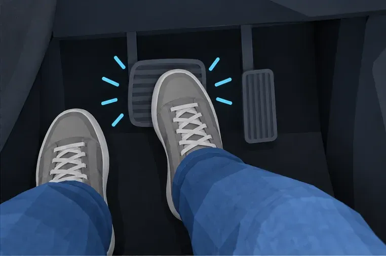 The right foot presses the wide brake pedal firmly. The blue marks show that the pedal vibrates.