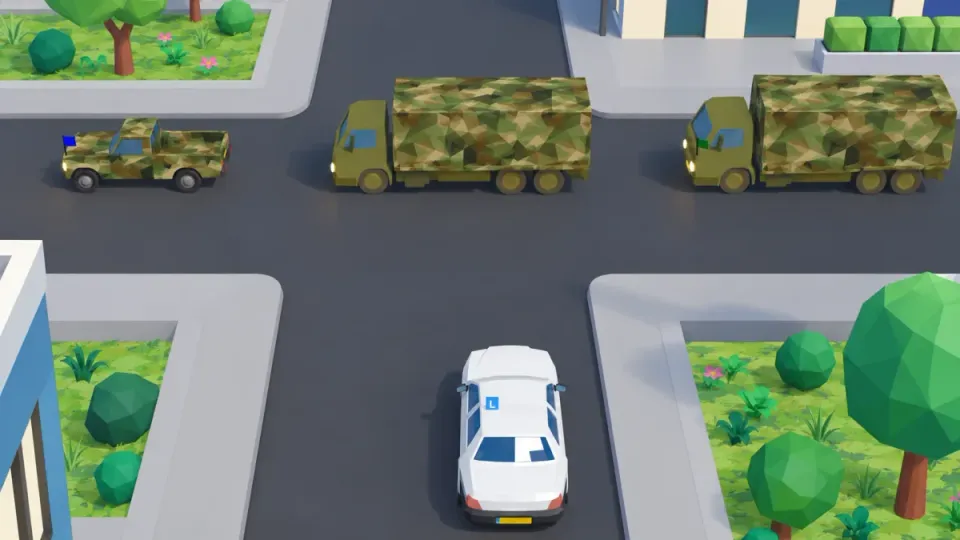 The convoy is already crossing the junction. The learner car waits until the last vehicle, with the green flag, has passed.
