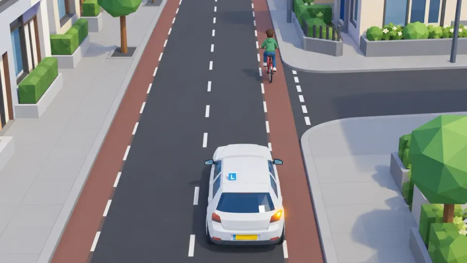 The learner car turns right and waits for the cyclist going straight on.