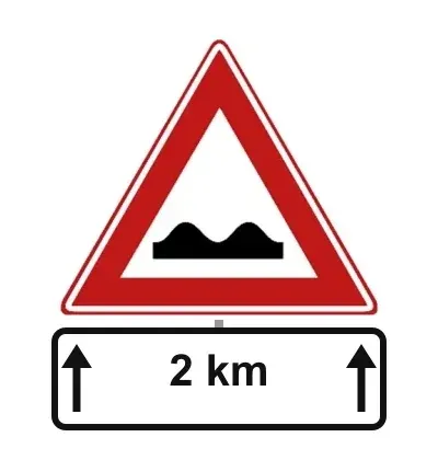 Sign J1 poor road surface with the sub-sign 2 km between two upward arrows