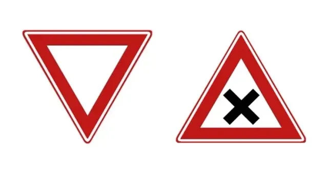 Left sign B6 with its point down, right warning sign J8 with its point up