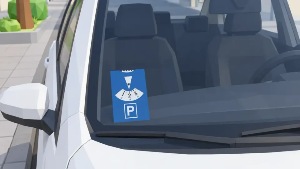 A blue parking disc stands on the dashboard on the passenger side, behind the windscreen