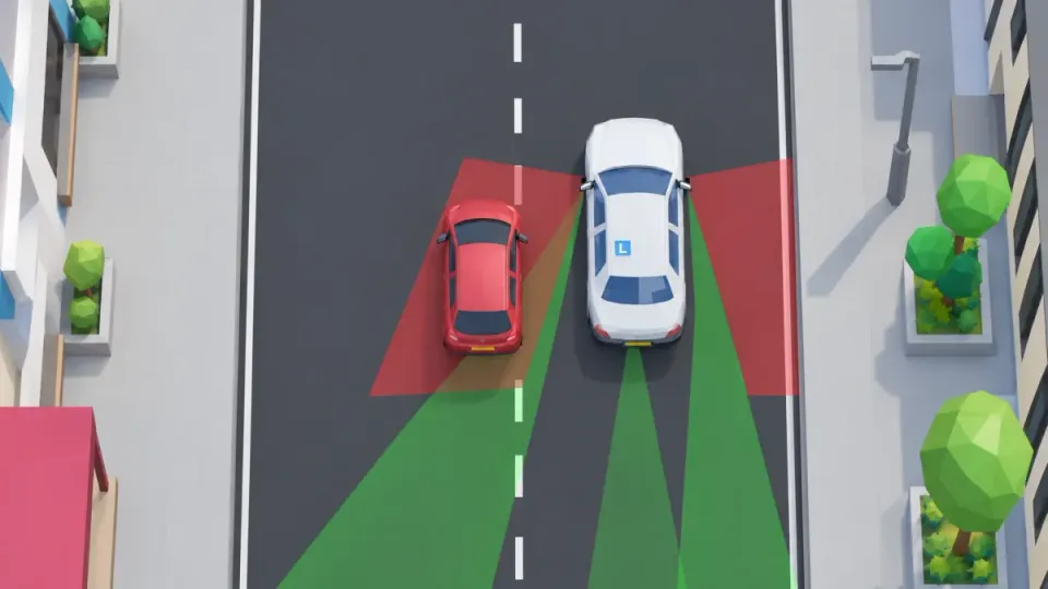 Green is what you see in your mirrors. Red is the blind spot: you cannot see the red car on the left in your mirror. So take a quick look over your shoulder.