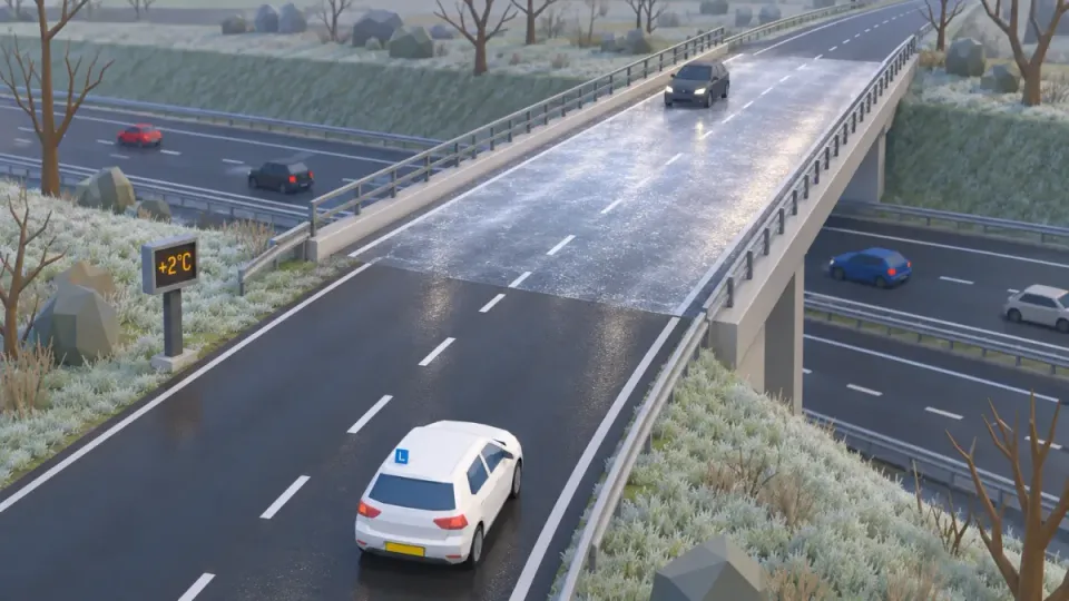 A viaduct over the motorway at +2 °C: the road before it is wet, the road surface on the viaduct is frozen